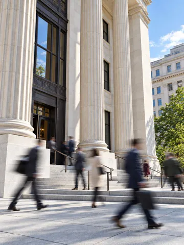 People walking outside a government building